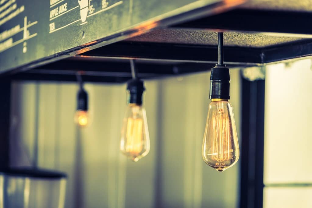 Exposed pendant bulbs beneath a commercial light fixture