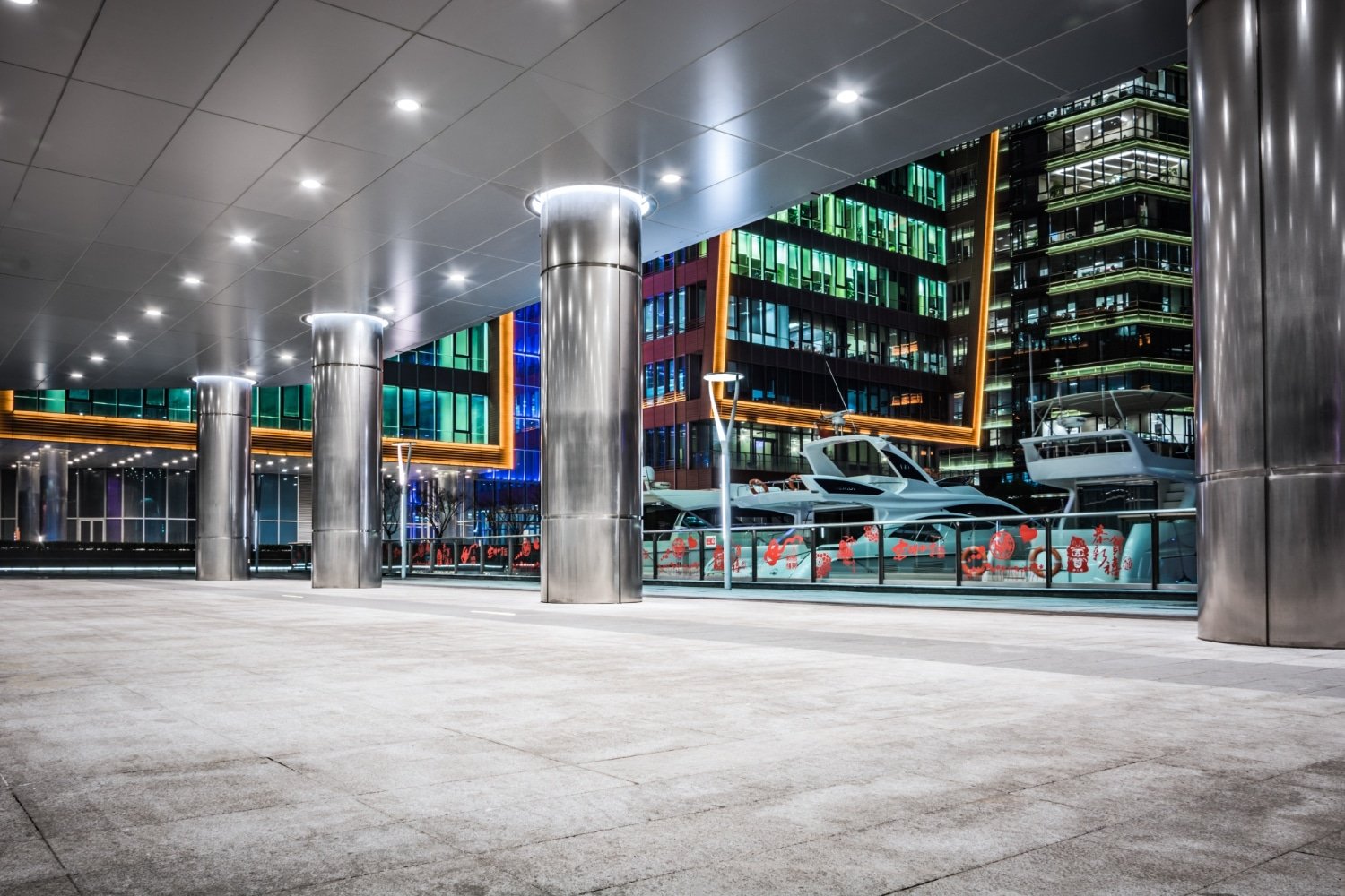 Ceiling downlights illuminating a covered waterfront walkway